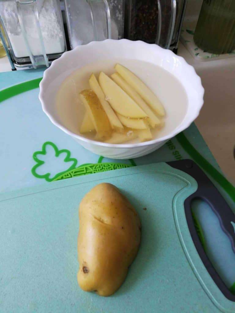 cutting potatos ready to make chips