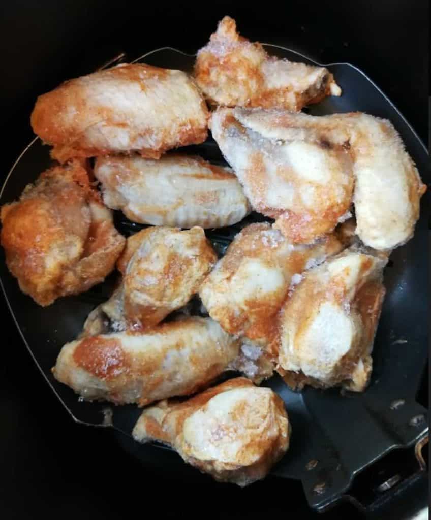 The frozen buffalo chicken wings waiting patiently in my Philips air fryer.