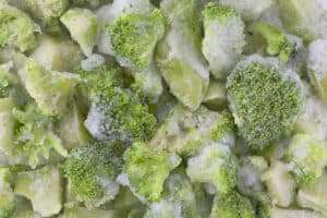 Frozen broccoli close up, with ice from the freezer.