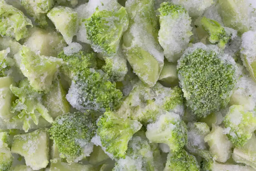 Frozen broccoli close up, with ice from the freezer.